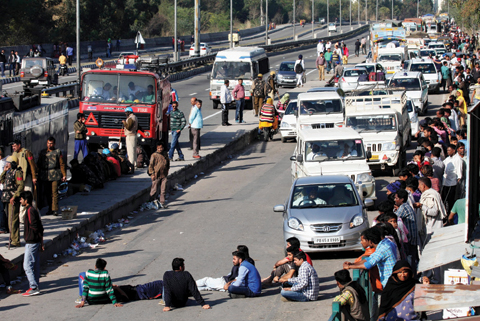 CHANDIGARH: Indian residents from the Jat community block the Chandigarh-Shimla highway amid violent caste protests in Panchkula yesterday.—AFP