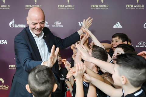 ZURICH: FIFA’s new president Gianni Infantino gives children from a football school high fives during the inauguration of the FIFA World Football Museum yesterday. — AFP