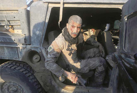 RAMADI: A member of Iraq’s elite counter-terrorism service sits in a vehicle after being wounded in fighting the Islamic State group’s jihadists in the Al- Sajariyah area, east of the city of Ramadi. —AFP