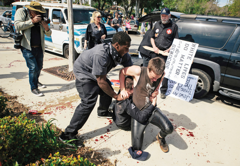 ANAHEIM: Counter-protesters scuffle with a KKK member on the ground as he stabs an attacking protester during an anti-immigration rally at Pearson Park on Saturday. — AP