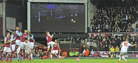 UPTON PARK: Liverpool’s Brazilian midfielder Philippe Coutinho (R) hits his freekick through the West Ham wall to score their first goal during the English FA Cup fourth round replay football match between West Ham United and Liverpool at The Boleyn Ground in Upton Park, east London, on Tuesday. — AFP