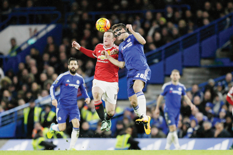 LONDON: Chelsea's Cesar Azpilicueta, right, competes for the ball with Manchester United's captain Wayne Rooney during the English PremiernLeague soccer match between Chelsea and Manchester United at Stamford Bridge stadium in London, yesterday. - APn
