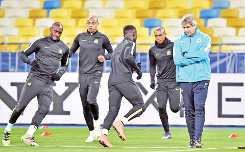 KIEV: Manchester City FC head coach Manuel Pellegrini (R) takes part in a training session at Olympiyski Stadium in Kiev yesterday, a day before the Champion's League, round of 16 football match between FC Dynamo Kiev and Manchester City. - AFP