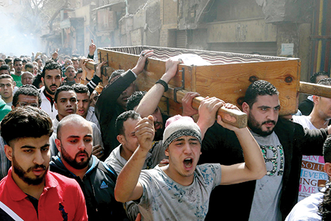 Egyptian mourners carry the coffin of Mohamed Ali Sayed Ismail, who was allegedly shot dead by a policeman over a fare dispute the day before, during his funeral on February 19, 2016 in the capital Cairo. Egyptian police said they had arrested an officer who allegedly shot dead Mohamed Ali Sayed Ismail over a fare dispute, following a rare protest against security abuses and a backlash on social media. Egyptian President Abdel Fattah al-Sisi will ask parliament to amend the law to toughen sanctions for police abuses, his office said Friday, a day after a police shooting sparked outrage in the country.  / AFP / ALAA EL-KASSAS