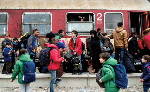 Migrants and refugees wait to board a train after crossing the Greek-Macedonian border near Gevgelija yesterday.