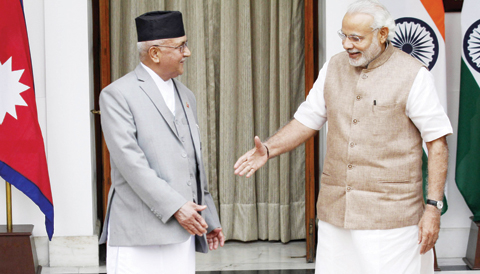 NEW DELHI: Nepalese Prime Minister Khadga Prasad Oli, left, prepares to shake hands with Indian Prime Minister Narendra Modi before their meeting in New Delhi yesterday. — AP