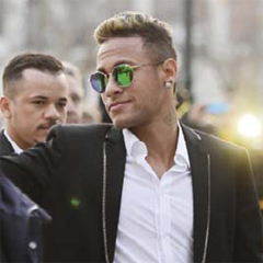 MADRID: Barcelona’s Brazilian forward Neymar (R) flashes the Victory sign as he leaves Spain’s national court in Madrid yesterday. — AFP