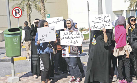 Students protest outside a local private university