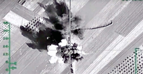 In this photo made from the footage taken from Russian Defense Ministry official website, an aerial image shows what it says is a column of heavy trucks carrying ammunition hit by a Russian air strike near Aleppo, Syria. — AP