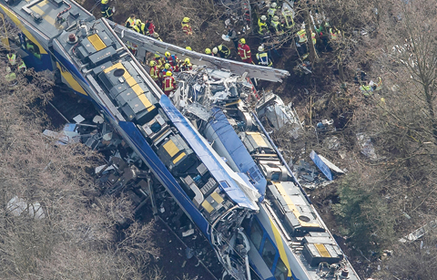 BAD AIBLING, Germany: An aerial view shows firefighters and emergency doctors working at the site of a train accident yesterday. - AFP 