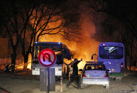 ANKARA: A police officer clears the area of an explosion in the Turkish capital yesterday. – AP 