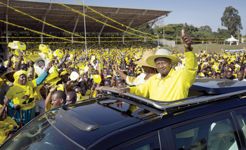 KAMPALA: Uganda’s long-time President Yoweri Museveni waves to supporters from the sunroof of his vehicle as he arrives for an election rally at Kololo Airstrip in Kampala, Uganda. — AP file photo