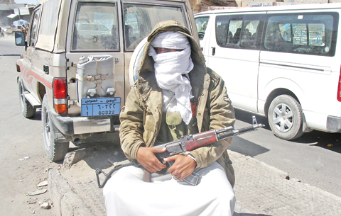 RADA: An Al-Qaeda militant sits with his gun in the city of Rada, 130km (85 miles) southeast of the Yemeni capital Sanaa. Rivals Al-Qaeda and the Islamic State group are cementing their presence in south Yemen in the absence of state authority and little opposition from pro-government Arab coalition forces, experts say. — AFP