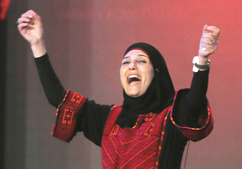DUBAI: Palestinian primary school teacher Hanan Al-Hroub reacts after she won the second annual Global Teacher Prize yesterday. – AP 