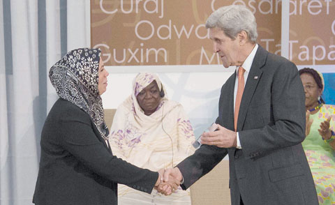 WASHINGTON: French recipient of the 2016 International Women of Courage Award, Latifa Ibn Ziaten (left), shakes hands with US Secretary of State John Kerry at the State Department in Washington. —AFP