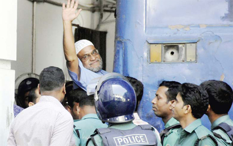 DHAKA: This file photo taken on November 2, 2014 shows Bangladeshi Jamaat-e-Islami party leader, Mir Quasem Ali waving his hand as he enters a van at the International Crimes Tribunal court. — AFP
