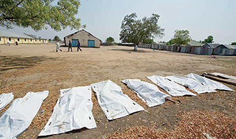 TO GO WITH AFP STORY BY PETER MARTELLn(FILES) This file photo taken on January 27, 2014 shows sheets covering the bodies of 16 people,  allegedly civilians killed when they took cover near Leudit church in Bor town, according to the South Sudanese military.nThe number of deaths in South Sudan's two-year civil has gone largely unrecorded. Estimates vary, with the UN sticking a guesstimate of 10,000 dead since the early months of the war, while the International Crisis Group (ICG), which has closely tracked the fighting, told AFP at least 50,000 had died a year into the war, in November 2014. Aid workers and officials who did not want to speak on the record said the true figure might be as high as 300,000 -- a figure comparable to the number killed in Syria during five years of fighting. / AFP PHOTO / ALI NGETHI