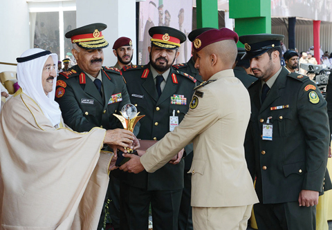 His Highness the Amir Sheikh Sabah Al-Ahmad Al-Jaber Al-Sabah honors a graduate.