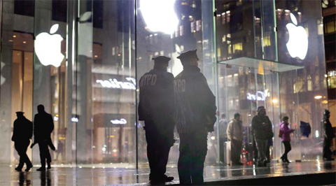 New York police officers stand outside the Apple Store on Fifth Avenue while monitoring a demonstration