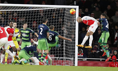 Arsenal's Theo Walcott, second right, fails to score during the English Premier League soccer match between Arsenal and Swansea City at the Emirates stadium in London