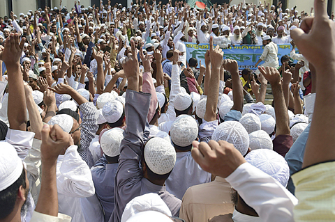 DHAKA: Bangladeshi hardline Islamists gather to protest outside the national mosque Baitul Mukarram in on Friday. —AFP