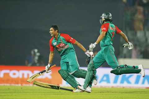 DHAKA: Bangladesh's captain Mashrafe Mortaza, right, and Mahmudullah celebrate after winning the Asia Cup Twenty20 international cricketnmatch against Pakistan in Dhaka, Bangladesh, yesterday. Bangladesh won by five wickets. – APn