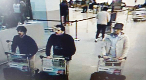 BRUSSELS: A picture released by the Belgian federal police shows a screen grab of the airport CCTV camera showing three suspects of yesterday’s attacks at Brussels Airport. — AFP
