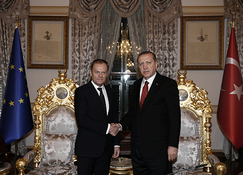 Turkey's President Recep Tayyip Erdogan, right, shakes hands with European Council President Donald Tusk for the media before a meeting in Istanbul, Friday, March 4, 2016. Tusk said Thursday it is up to Turkey to decide what further measures it can take to reduce the flow of migrants but says many in Europe favor a mechanism that would allow the ìfast and large-scaleî shipment of migrants back to Turkey and such a mechanism would ìeffectively break the business model of the smugglers. (Yasin Bulbul/Presidential Press Service, Pool via AP)