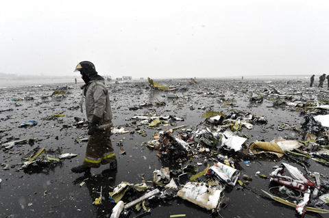 ROSTOV-ON-DON: Russian fire servicemen check the wreckage of the Dubai plane that crashed at the Rostov-on-Don airport yesterday. (Inset) Ghaith Al Ghaith, Chief Executive Officer of Flydubai reacts during a press conference. – AFP 