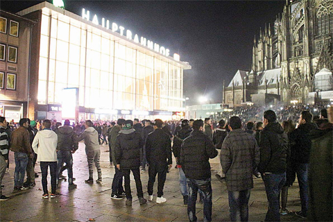 COLOGNE: This photo taken on December 31, 2015 shows people gathering in front of the main railway station where a rash of sexual assaults in crowds on New Year’s Eve drew intense media coverage. —AFP