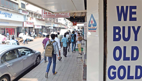 MUMBAI: Indians walk past closed jewelry shops at Zaveri Bazar — the centre of India’s jewelry trade-in Mumbai yesterday. Jewelers across gold-loving India started a three-day strike yesterday in a bid to force the government to shelve plans for a controversial excise tax announced in this week’s budget. — AFP