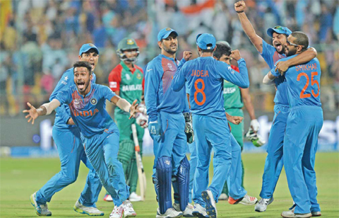 BANGALORE: Indian players including Hardik Pandya (L) and captain Mahendra Singh Dhoni (C) celebrate the wicket that led to the victory of India by 1 run during the World T20 cricket tournament match between India and Bangladesh at The Chinnaswamy Stadium. — AFP