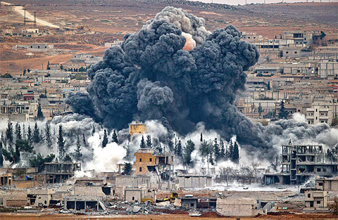 KOBANI: Smoke rises following an airstrike by the US led coalition, seen from a hilltop outside Suruc, on the Turkey-Syria border. —AP