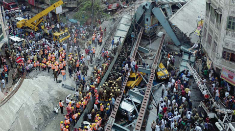KOLKATA: Indian rescue workers and volunteers try to free people trapped under the wreckage of a collapsed fly-over bridge yesterday. — AFP