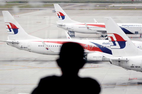 KUALA LUMPUR: A man views a fleet of Malaysia Airline planes on the tarmac of the Kuala Lumpur International Airport in Malaysia. The head of one of the world’s top air crash investigation agencies says not enough is being done to adopt already available technologies that can help prevent another plane with hundreds of passengers from simply disappearing like MH370. — AP
