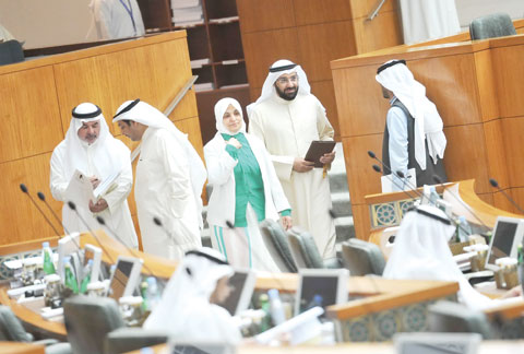 KUWAIT: The Minister of Social Affairs and Labor and Minister of State for Planning and Development Affairs Hind Al-Subaih (center) is pictured with some Kuwait MPs during the parliamentary session yesterday. — Photo by Yasser Al-Zayyat