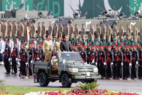 ISLAMABAD: Pakistan’s President Mamnoon Hussain, center on a military vehicle, reviews a military parade to mark Pakistan’s Republic Day yesterday. — AP