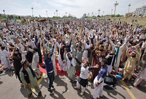 ISLAMABAD: Protesters from Pakistan’s Sunni Tehreek group chant slogans during a sit-in near the parliament building yesterday. — AP