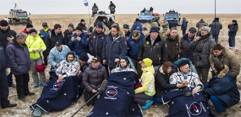 KAZAKHSTAN: Russian cosmonauts Mikhail Kornienko (left), Sergey Volkov, (center) and US astronaut Scott Kelly rest in chairs outside the Soyuz TMA-18M space capsule after they landed in a remote area outside the town of Dzhezkazgan. — AP photos