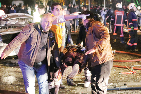 ANKARA: People carry an injured person on a stretcher at the scene of a blast yesterday. – AFP 