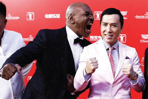 File photo shows retired professional boxer Mike Tyson (left) of the US joking around with Hong Kong-US actor Donnie Yen (right) as they arrive on the red carpet for the opening ceremony of Shanghai International Film Festival in Shanghai. — AP