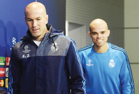 MADRID: Real Madrid's French coach Zinedine Zidane (L) and Real Madrid's Portuguese defender Pepe arrive to a press conference yesterday at Real Madrid Sport City in Madrid on the eve of their UEFA Champions League football match Real Madrid CF vs AS Roma. - AFP