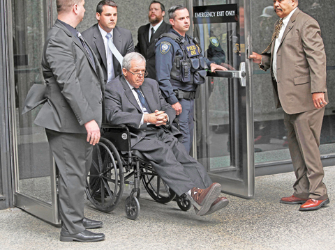 CHICAGO: Former House Speaker Dennis Hastert leaves the Dirksen Federal Court House in a wheelchair after his sentencing yesterday. — AFP