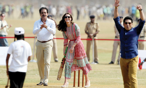 MUMBAI: Former Indian cricketers Dilip Vengsarkar (left)and Sachin Tendulkar(second right)looks on as Catherine, Duchess of Cambridge(center)and an unseen Britain's Prince William, Duke of Cambridge play a game of cricket with Indian children who are beneficiaries of NGO's at The Oval Maidan. - AFP 