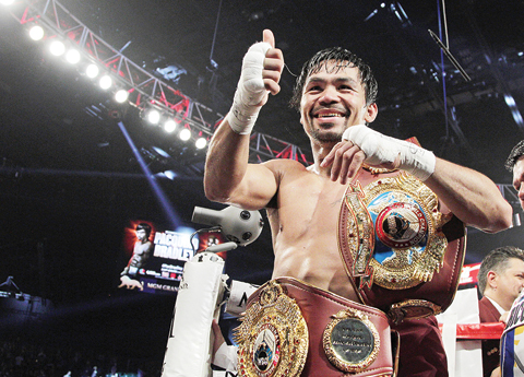 Manny Pacquiao gestures to fans as he celebrates after defeating Bradley Jr