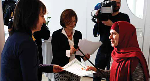 VIENNA: An Austria based graduate from Chechnya receives her diploma from Maynat Kurbanova (left) of the so called “motherschool” on March 8, 2013. — AFP