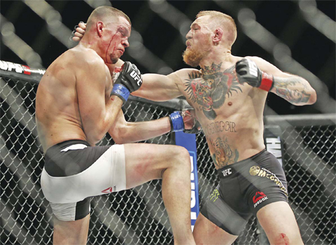 LAS VEGAS: In this Saturday, March 5, 2016 file photo, Conor McGregor, right, trades punches with Nate Diaz during their UFC 196 welterweight mixed martial arts match in Las Vegas. Conor McGregor has packed a punch on social media rather than inside a UFC cage. One of the UFC’s top draws, McGregor created a stir Tuesday when he tweeted that retirement was on the horizon. — AP