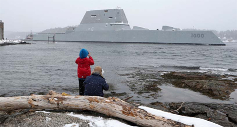 PHIPPSBURG, MAINE: Dave Cleaveland and his son, Cody, photograph the USS Zumwalt as it passes Fort Popham at the mouth of the KennebecnRiver as it heads to sea for final builder trials. — AP