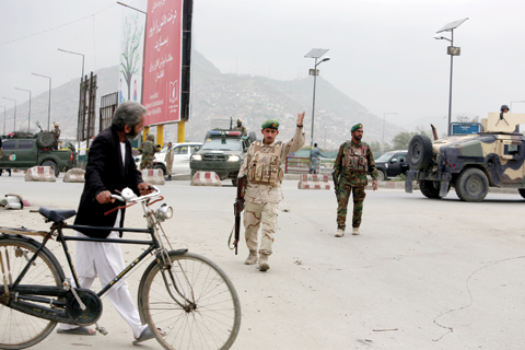 KABUL: Afghan security forces secure the area after a suicide attack on Tuesday.-AP