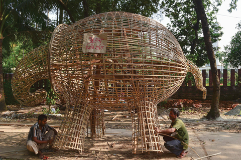 DHAKA: Bangladeshi residents prepare an installation at Dhaka University as a part of Bengali New Year preparations in Dhaka. The Bengali calendar is solar, with the year beginning on Pohela Boishakh, which this year falls on April 14, in Bangladesh. — AFP
